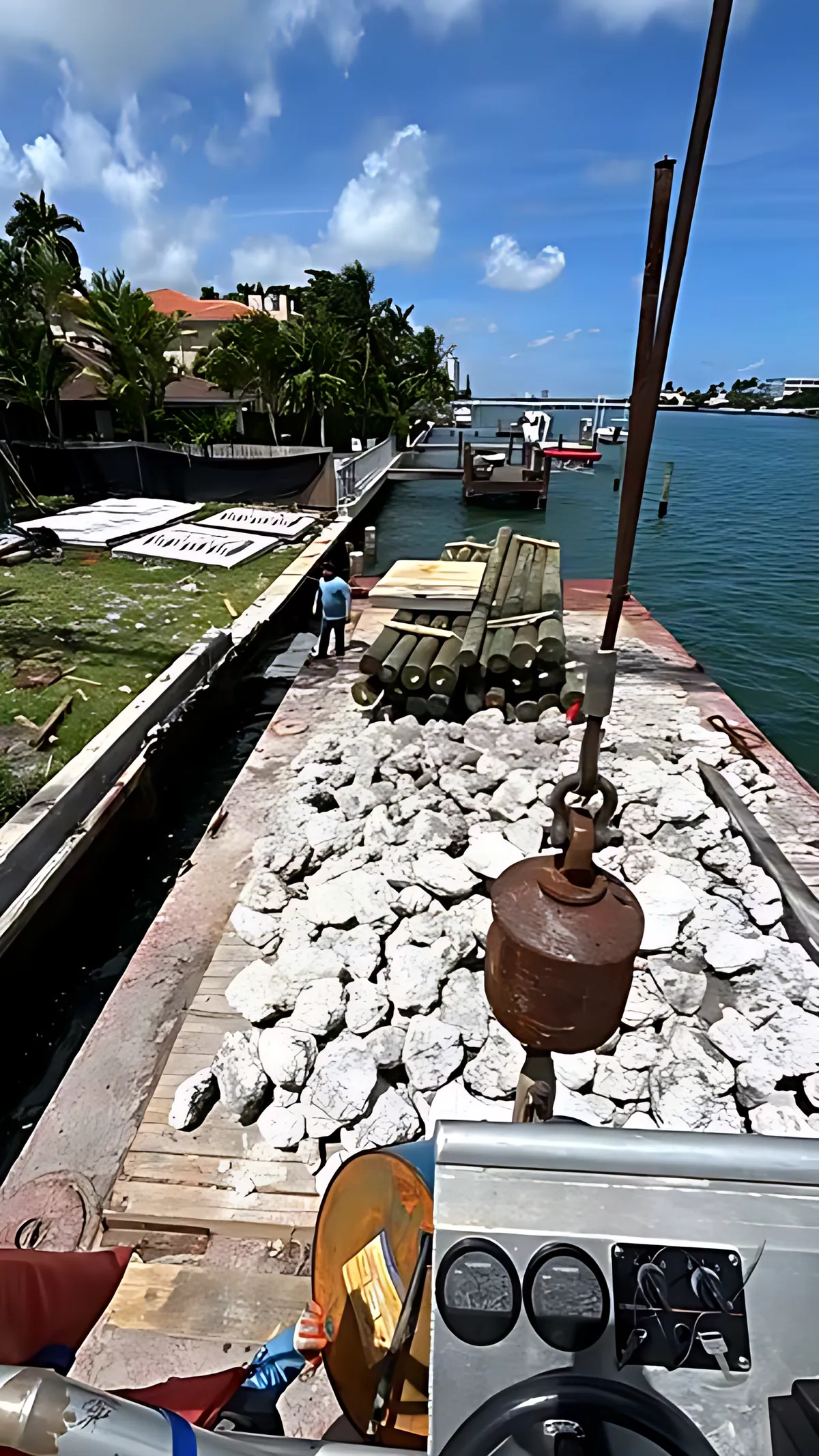 Work barge loaded with stone on a Miami waterway