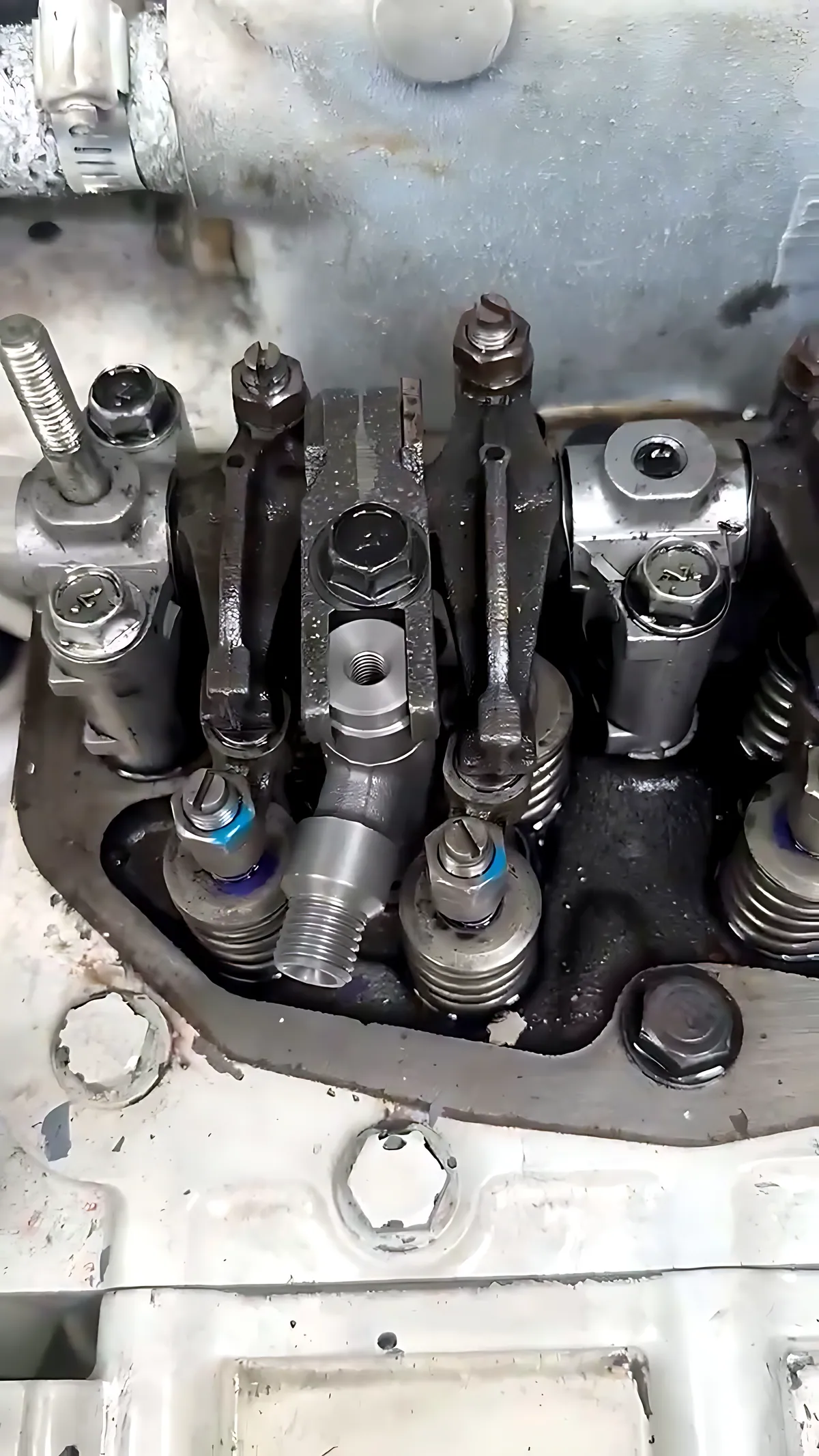 Open cylinder head showing rocker arms and injectors on a marine diesel